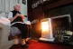 An elderly lady holding a cup of tea at home in Liverpool wi