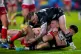 Hull KR's James Batchelor is tackled by Hull FC's Davy Litte