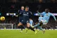 Manchester City's Jeremy Doku (right) attempts a shot on goa