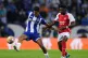 Porto's Galeno (left) and Arsenal's Bukayo Saka battle for t