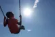 A child a swinging on a swing in Liverpool