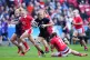 England's Zoe Aldcroft (centre) is tackled by Wales's Lleucu