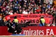 Manchester United fans hold up a banner in protest of the Gl