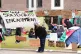 A student adjusts a sign at an encampment on the grounds of 