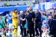 Referee Stuart Attwell (partially visible) shows a yellow ca