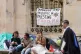 People sit near an encampment protest over the Gaza conflict