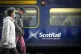 Commuters walking past a ScotRail train at Edinburgh's Waver