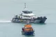 An RNLI Lifeboat and a Border Force vessel in Dover, Kent, f