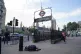 A homeless person asleep on the street beside the entrance t