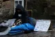 A homeless person and their dog on the Royal Mile in Edinbur