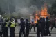 Police officers with protesters as trouble flares during an 