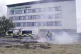 A police officer extinguishes a small fire during an anti-im