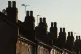 Chimneys on a row of terraced residential houses in south ea