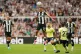 Newcastle United's Bruno Guimaraes (centre) clears the ball 