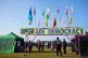 Police officers walk beneath a banner reading 'upgrade democ