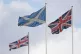 A Saltire flag is flanked by Union flags flying above Whiteh