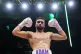 Adam Azim celebrates winning the Super-Lightweight bout agai