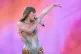 Taylor Swift performing on stage during her Eras Tour at the