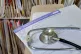 A registration form and a stethoscope at a GP Practice 
