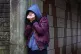 A teenage girl with her head in her hands