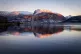Ben Nevis is reflected in Loch Linnhe at sunset near Fort Wi