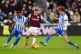 West Ham United's Jarrod Bowen (centre) battles with Brighto