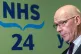 First Minister John Swinney during his visit to NHS 24 call 