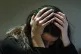 A woman holding her head in her hands