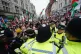 People breach a police line whilst taking part in a national
