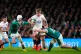 England's Fin Smith tackled by Ireland's Mack Hansen and Jac