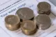 Money is stacked on top of an water bill