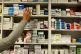 A pharmacist stocking shelves