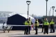 Police officers and a police forensic tent outside the Lifeb