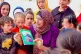 Asma Mustafa reads a book to children in Gaza