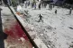 Blood can be seen in the aftermath of the Israeli strike on 