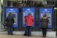 People using cash machines in Halifax in Yorkshire
