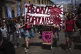 Protesters march with a banner that reads 