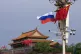A Russian and Chinese national flag flutter near Tiananmen G