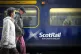 Commuters walking past a ScotRail train at Edinburgh's Waver
