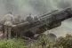 Ukrainian soldiers prepare to fire at Russian positions from