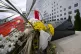 A Chinese flag is placed near flowers on a monument at the s