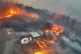 Houses burn in a village after being engulfed by a wildfire 