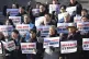 Members of civic groups shout slogans during a rally demandi