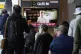 People watch a TV screen showing former South Korea's main o