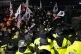 Police officers stand guard as supporters of impeached South
