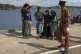Two women and a man, center, believed to be Rohingya refugee