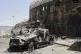 A burned military vehicle sits at Khartoum international air