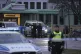 Police officers stand guard near the scene of a shooting at 