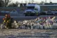 Flowers and candles are placed at a makeshift memorial near 