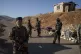 Members of the new security forces stand guard at a checkpoi